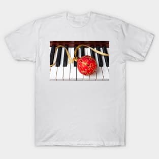 Christmas ornament on piano keys T-Shirt